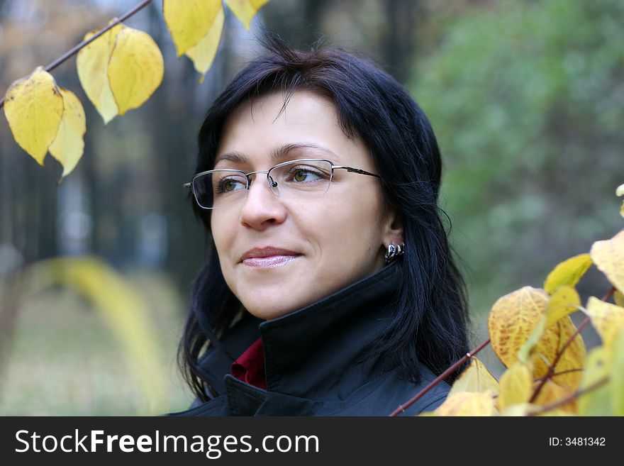 Young woman with black hair in glasses, autumn shot. Young woman with black hair in glasses, autumn shot