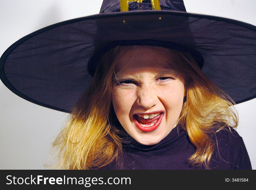 Young angry witch with a black teeth. Young angry witch with a black teeth