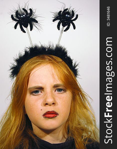 Young angry girl with a black tiara on