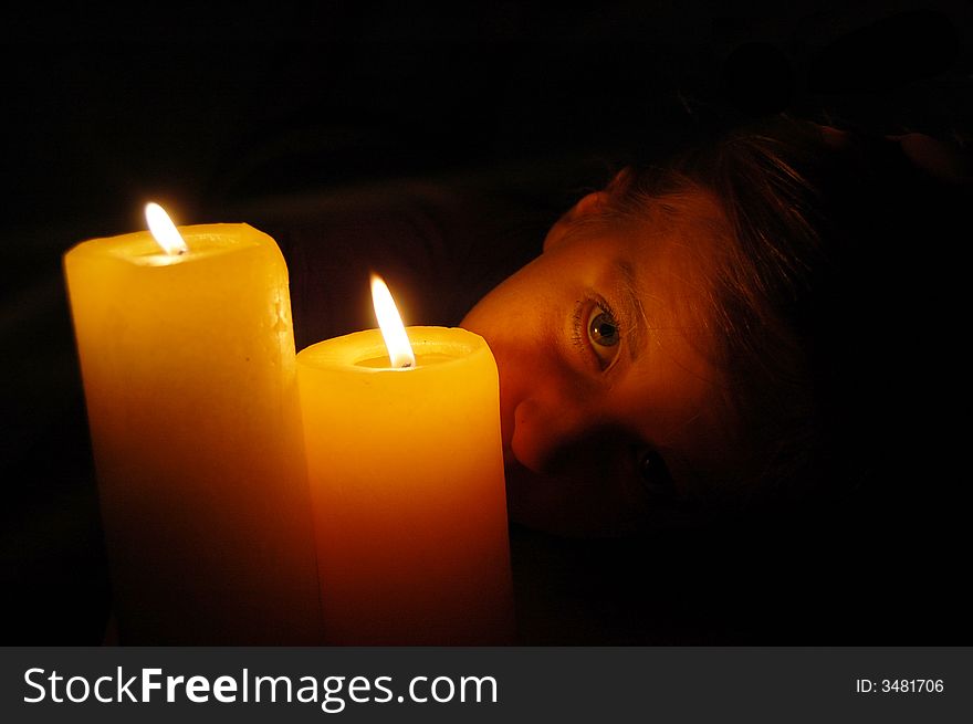 Young girl with candlelight looking creepy. Young girl with candlelight looking creepy