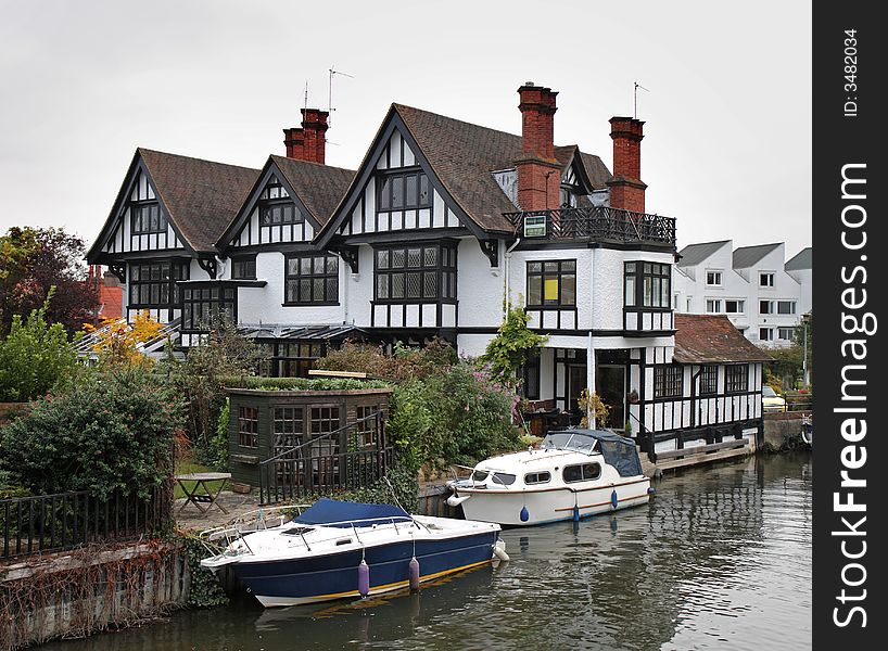 Timber Framed Houses and Moored Boats on the River Thames in England. Timber Framed Houses and Moored Boats on the River Thames in England