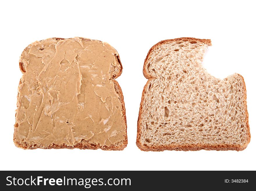 Two slice of bread, the first one is buttered but the second is bitten. Two slice of bread, the first one is buttered but the second is bitten