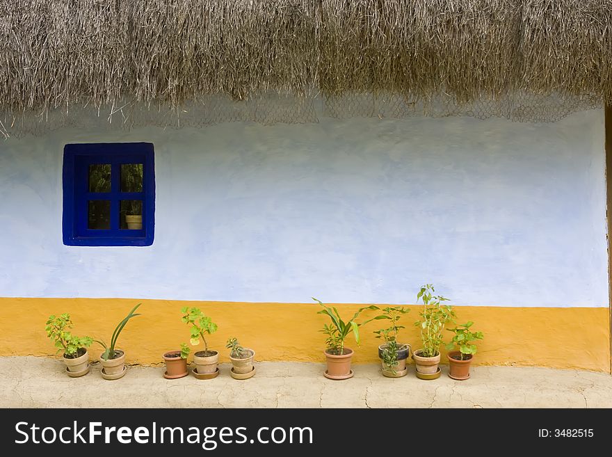 Wall of traditional antique house with blue window. Wall of traditional antique house with blue window