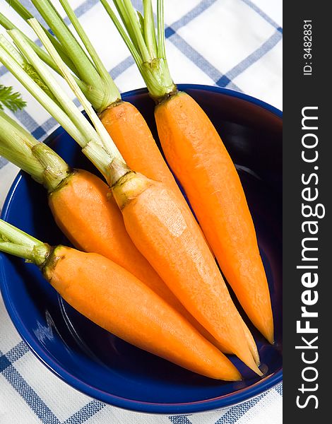 Fresh carrots in the blue bowl