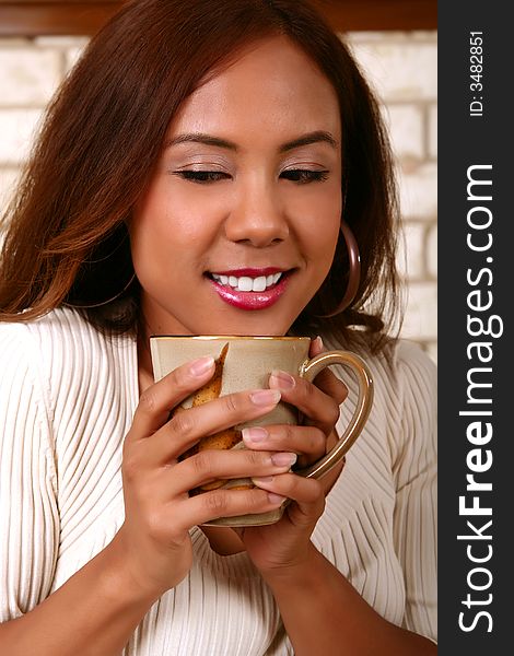 Beautiful model smelling her morning coffee. skin was smoothen no noise reduction used. Beautiful model smelling her morning coffee. skin was smoothen no noise reduction used