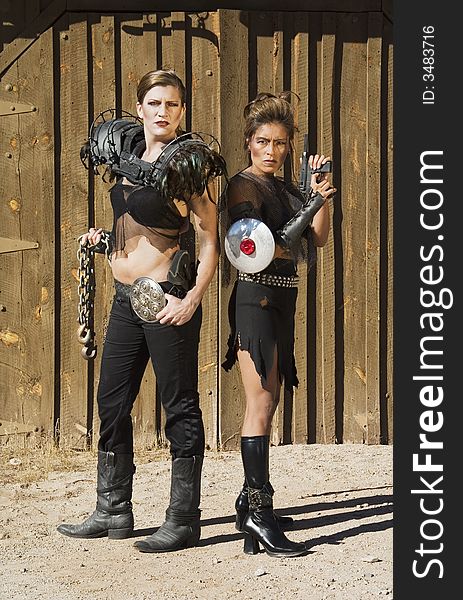Tough science-fiction women in costumes with weapons. Tough science-fiction women in costumes with weapons.
