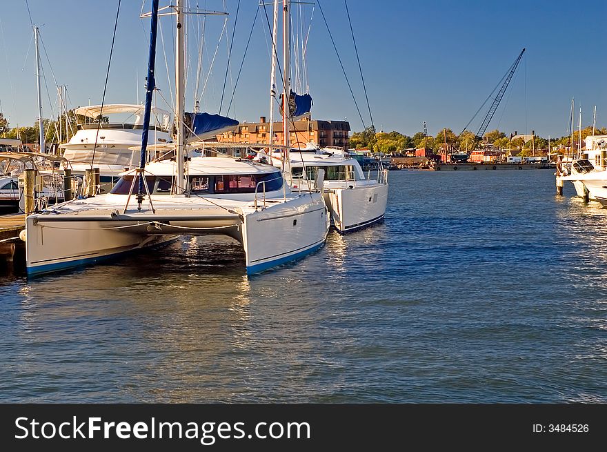 A view of two, double-hulled catamaran sailboats, docked at a marine in Annapolis, Maryland (USA). A view of two, double-hulled catamaran sailboats, docked at a marine in Annapolis, Maryland (USA).