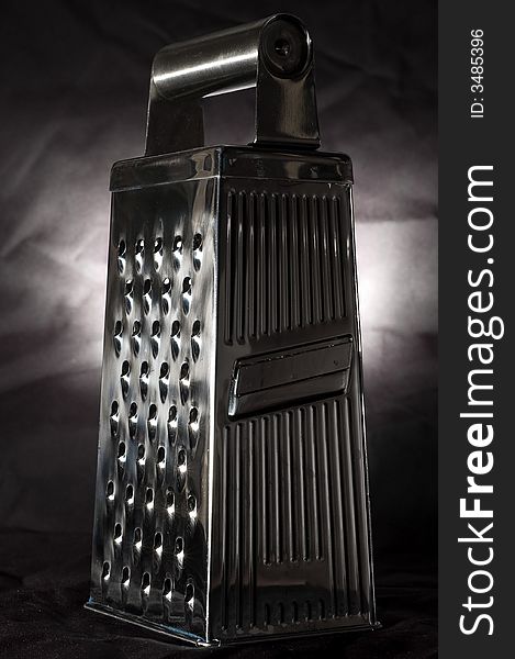 Stylish parmesan grater, isolated on black