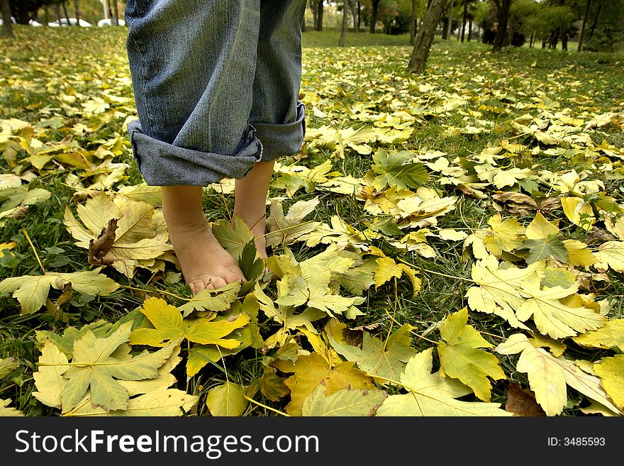 A view with bare feet resting on grass. A view with bare feet resting on grass