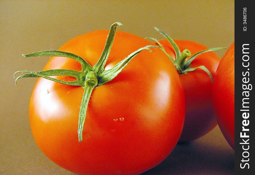 Image from vegetable series: tomatos on brown background