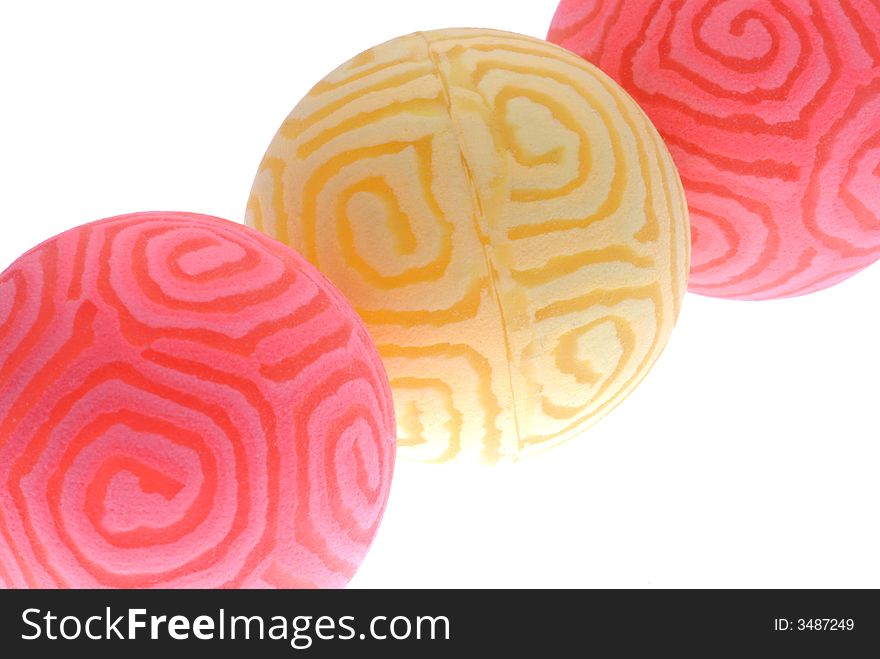 Close up image of pink and yellow toy balls