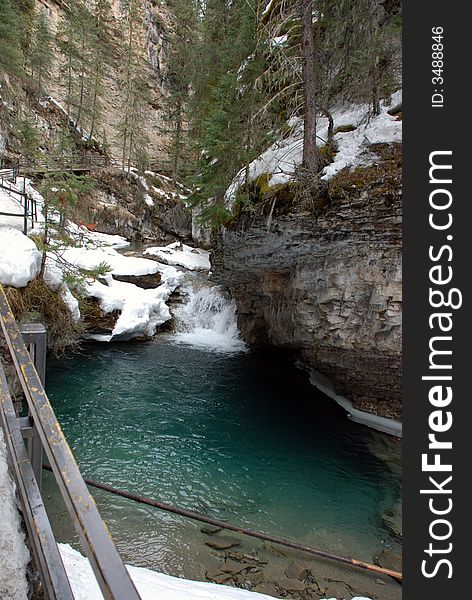 Beautiful parcially frozen stream through a deep canyon in the Canadian Rocky Mountains. Beautiful parcially frozen stream through a deep canyon in the Canadian Rocky Mountains.