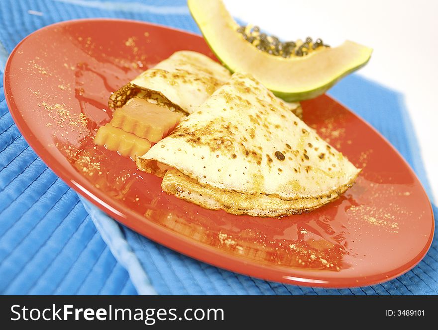 Crepes served with fresh papaya. Crepes served with fresh papaya