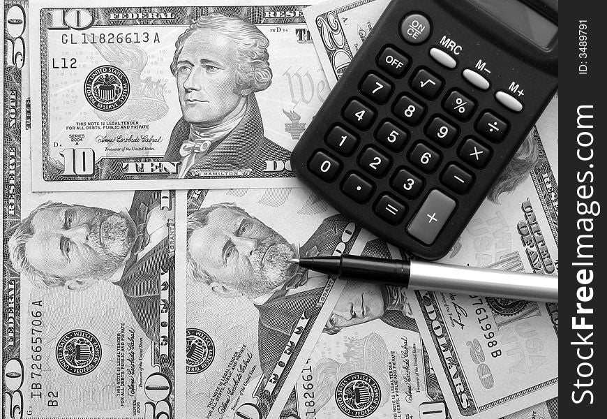 A black and white version of a photo of a calculator and a pen over a background formed by dollar bills. A black and white version of a photo of a calculator and a pen over a background formed by dollar bills