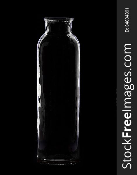 Elegant silhouette of a long bottle on a black background