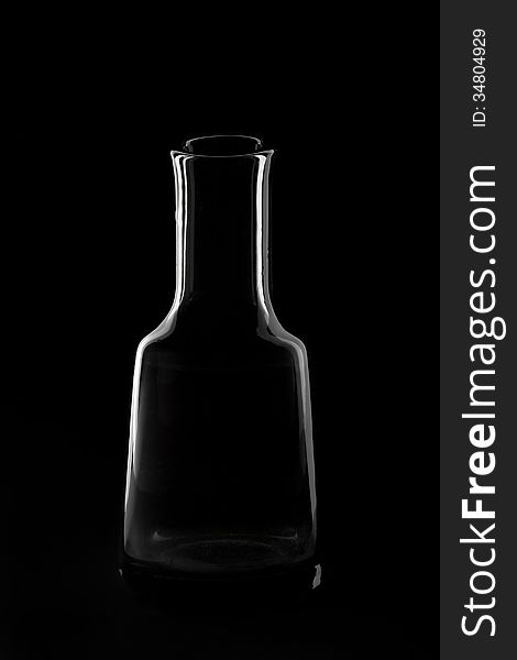 Elegant silhouette of the bottle on a black background