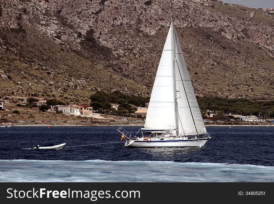 Sloop sailing close to Alicante coast. Sloop sailing close to Alicante coast