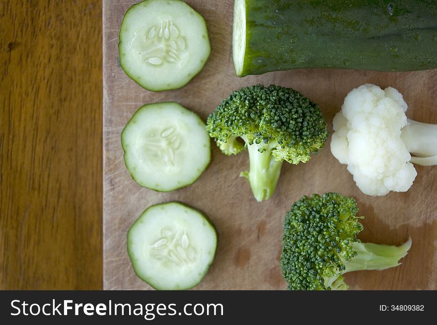 Fresh green vegetables on wooden background