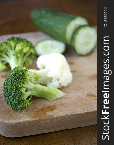 Green vegetables on wooden cutting board