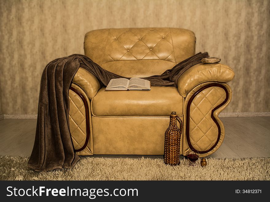 Comfortable chair for home entertainment, books, wine and an ashtray