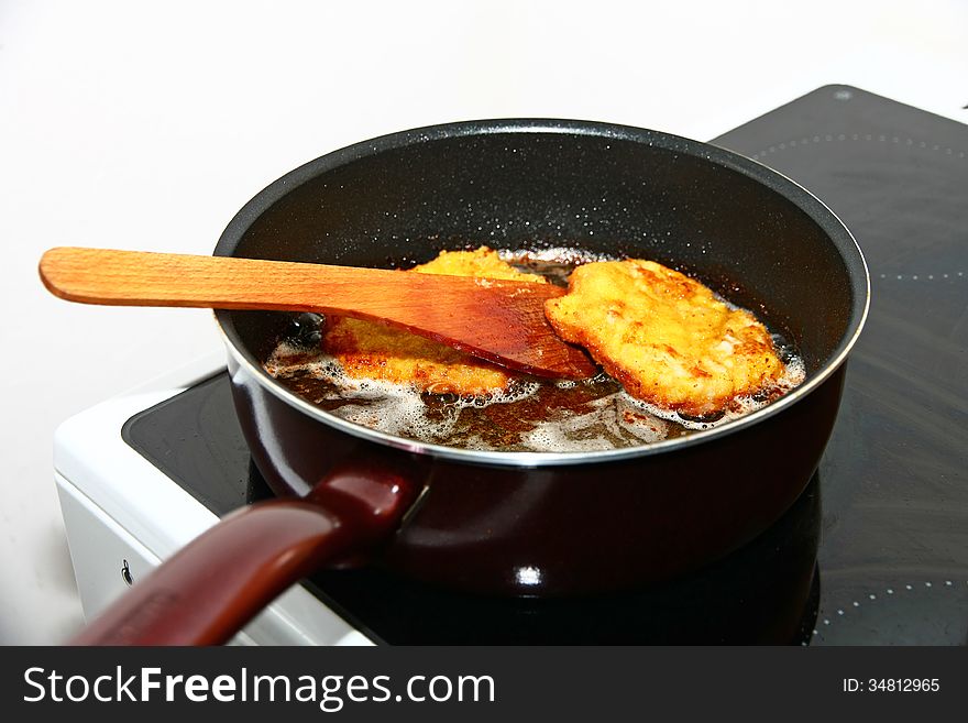 Wooden spoon fester steak in the pan. Wooden spoon fester steak in the pan