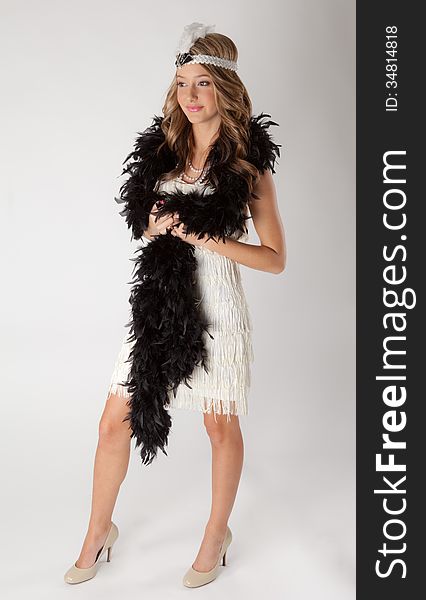 An image of a pretty teen in a flapper costume. An image of a pretty teen in a flapper costume