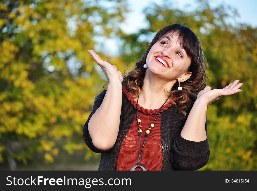 Woman laughing in park during summer. Happy smiling beautiful young woman outside in summer dress.