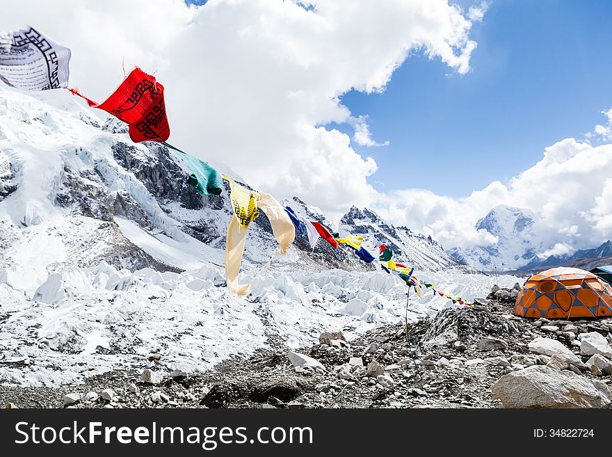 Khumbu glacier in Everest Base Camp, Himalaya Mountains, Nepal. Prayer flags and snow in camping site on rocks. Khumbu glacier in Everest Base Camp, Himalaya Mountains, Nepal. Prayer flags and snow in camping site on rocks.