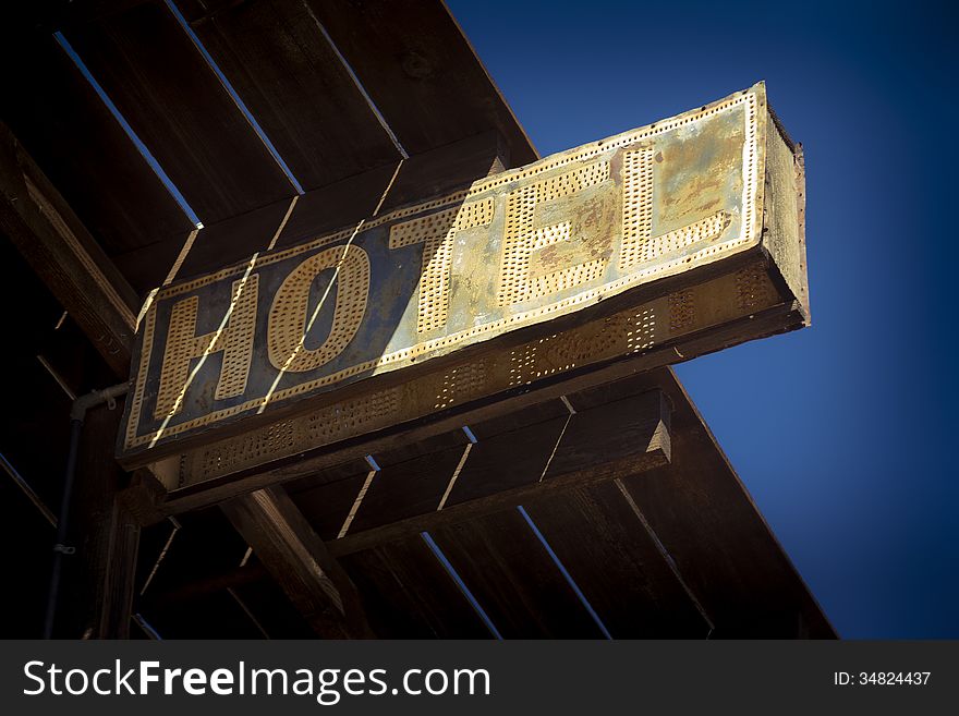 Vintage hotel sign weathered by exposure to hot sunshine