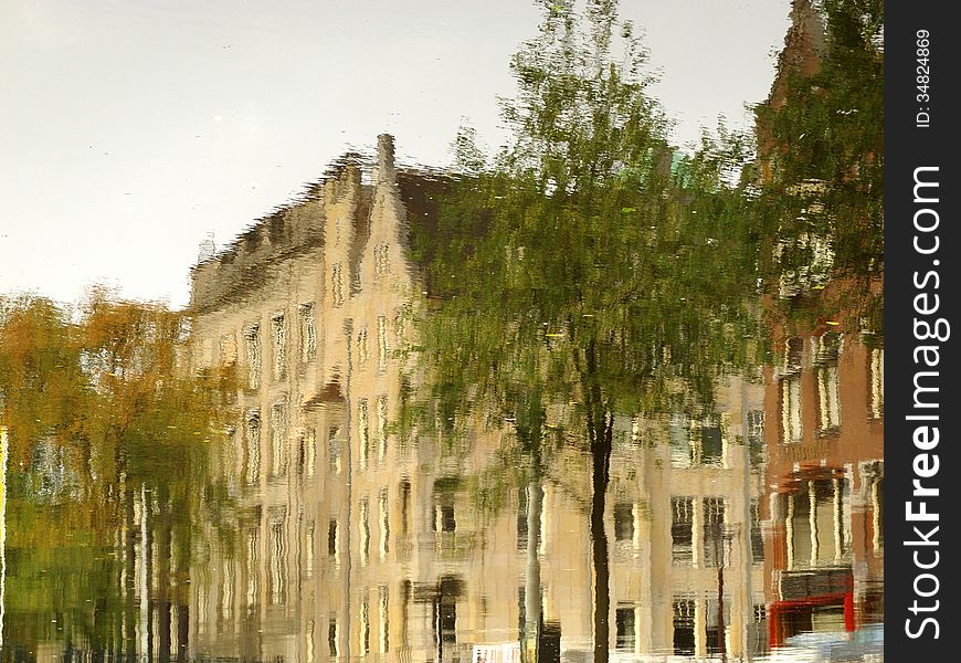 A typical Amsterdam series of building reflected on the calm water of a canal. Image is rotated by 180 degrees. A typical Amsterdam series of building reflected on the calm water of a canal. Image is rotated by 180 degrees.