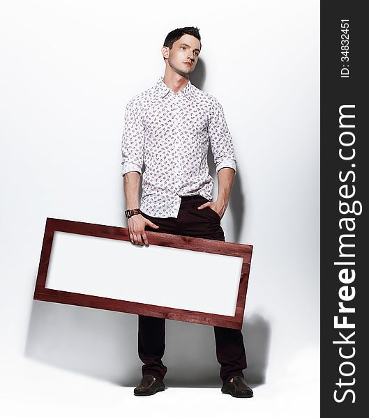 Fashion Man Holding Board With White Blank Space For Text
