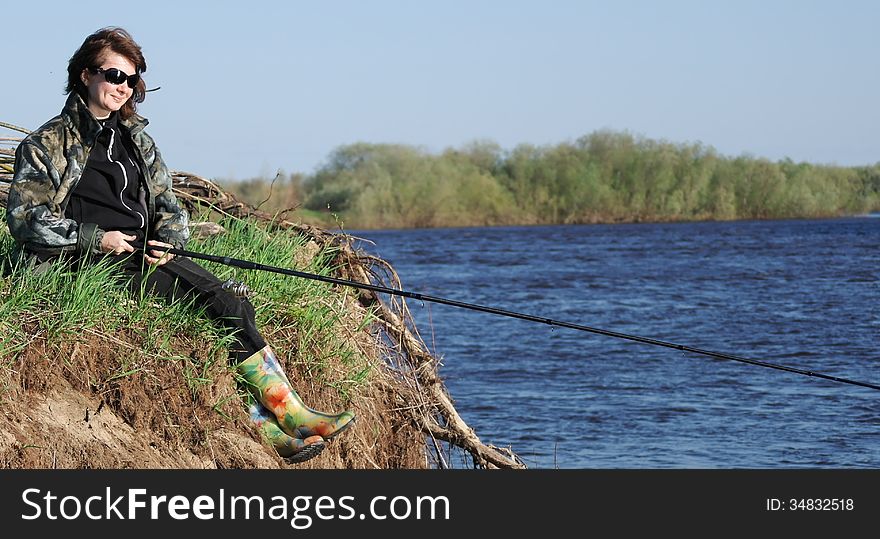 woman fishing on the Bank of the river. woman fishing on the Bank of the river