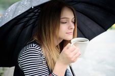 Womanl Drinks Fragrant Coffee With Pleasure Under Umbrella Royalty Free Stock Photos Womanl Drinks Fragrant Coffee With Pleasure Under Umbrella Royalty Free Stock Photos