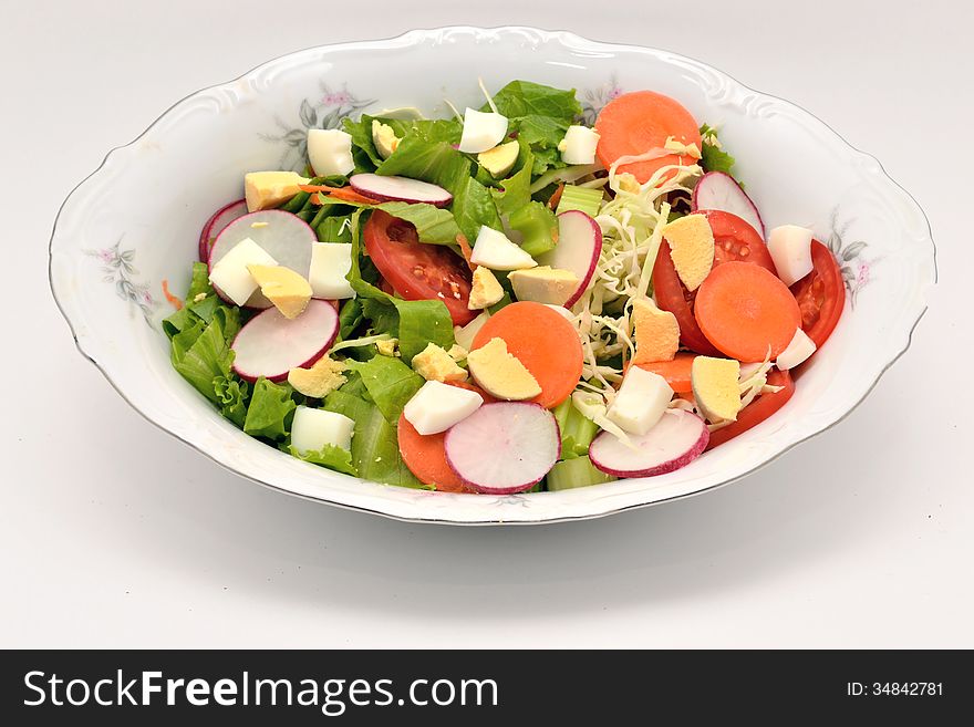 Ingredients for a tasty vegetable salad on white background