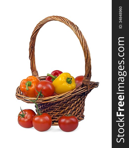 Multi-colored vegetables in a wicker basket and near it. Multi-colored vegetables in a wicker basket and near it