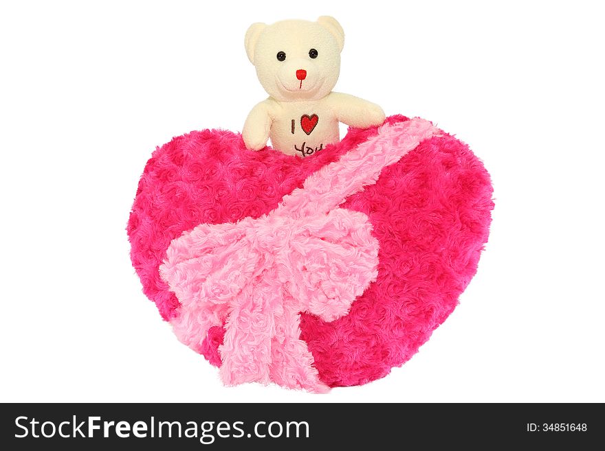 Teddy bear above red heart