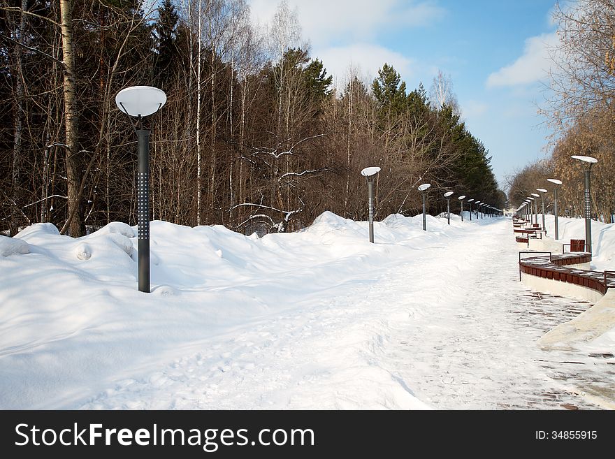 The path filled up by snow in small town park