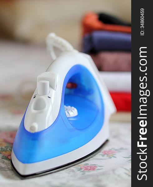 Steam iron and pile of cloth