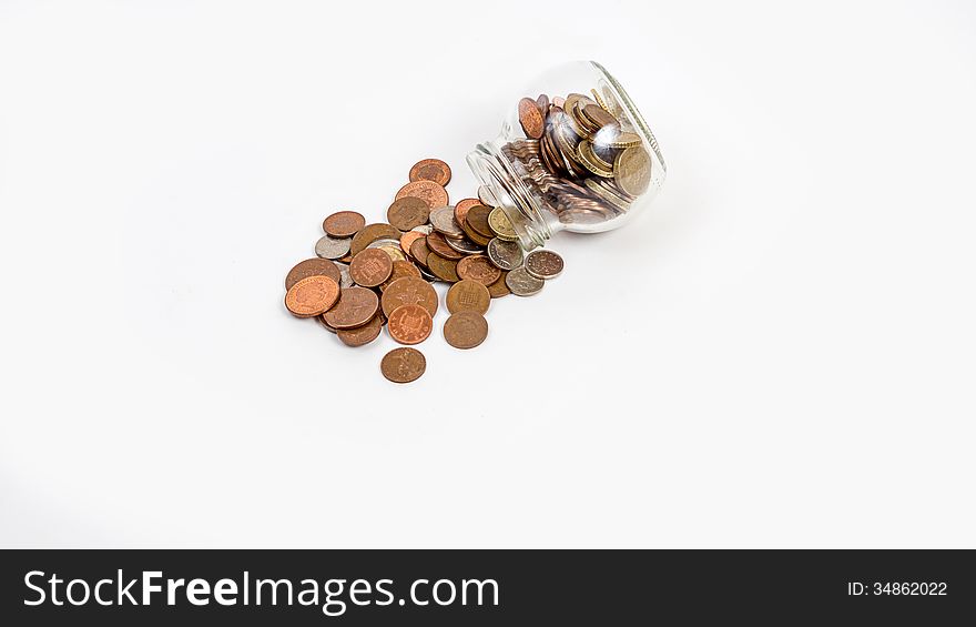 Coins spilt from jar isolated on white background. Coins spilt from jar isolated on white background