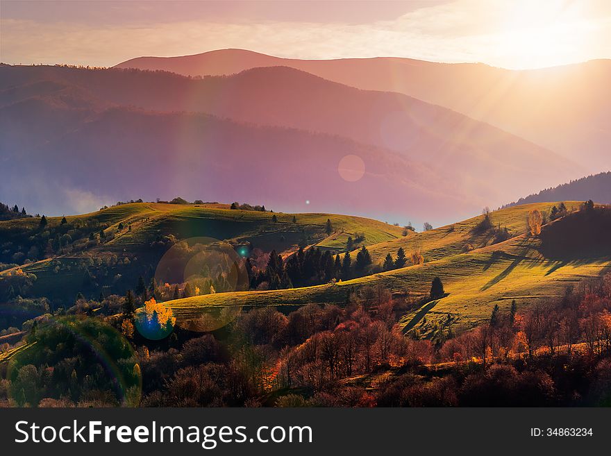 Autumn landscape. forest on a hillside covered with red and yellow leaves. over the mountains. Autumn landscape. forest on a hillside covered with red and yellow leaves. over the mountains