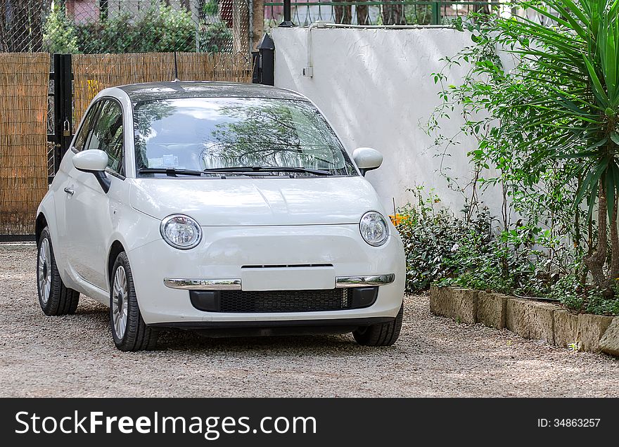 Small car outdoors. In private place.