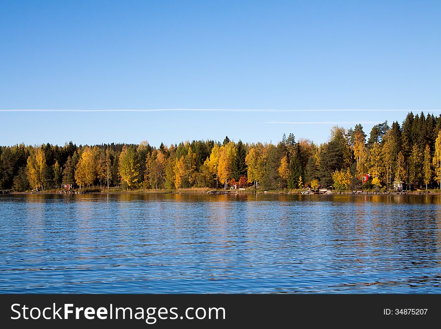 Autumn lake with trees mirroring in Finland. Autumn lake with trees mirroring in Finland