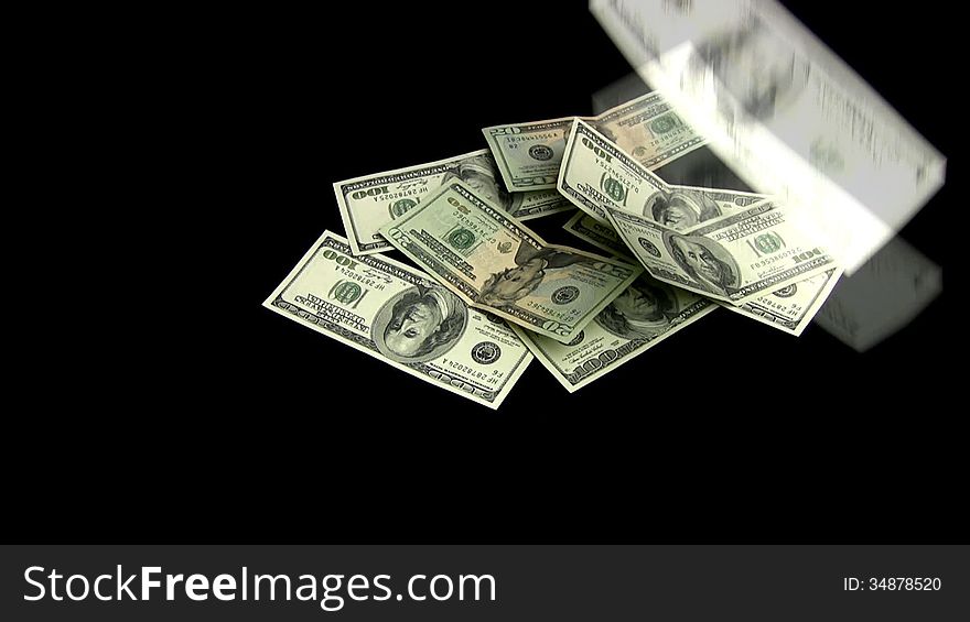 The dollars on a black background fall and the heap is going. The dollars on a black background fall and the heap is going