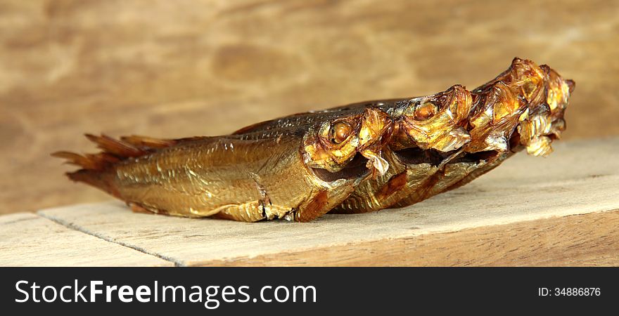 Smoked fish on brown background