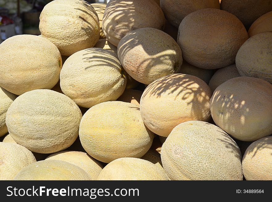 Fresh ripe cantaloupe for sale at an outdoor market