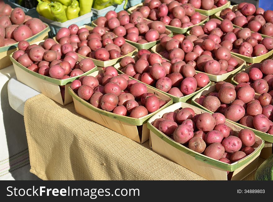 Baskets full of clean organic potatoes for sale at a local Farmers market in rural Michigan, USA