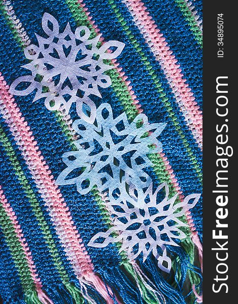 Warm knitted scarf with fringe with snowflakes. Warm knitted scarf with fringe with snowflakes