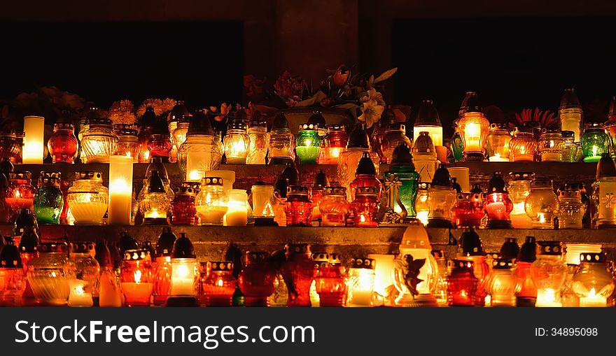 Burning candles at night in the cemetery.