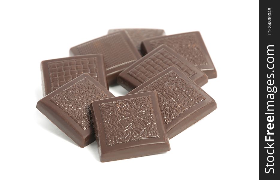 Close-up of chocolate pieces on a white background