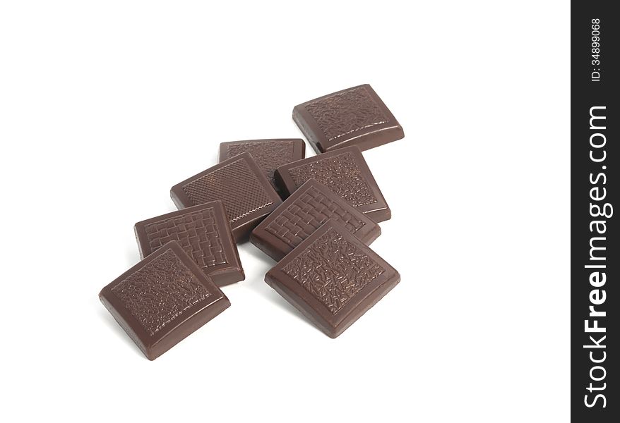 Close-up of chocolate pieces on a white background